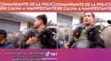 Efectivo de la policía pide a manifestante marchar pacíficamente.