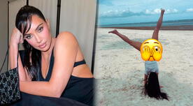 Kim Kardashian luce su destreza en la gimnasia frente al mar en diminuto bikini negro