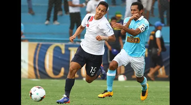 Christian Ortiz conduce el balón ante Carlos Lobatón.