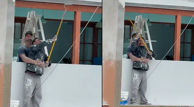 Pintor decide usar los brazos de su compañero como seguridad antes que un arnés Pintor decide usar los brazos de su compañero como seguridad antes que un arnés
