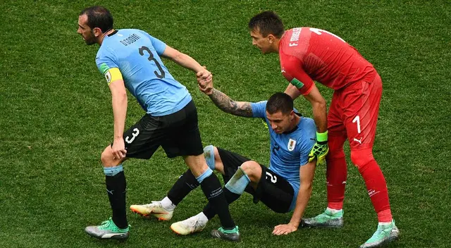 Godín y el golero Muslera consolando a Giménez.