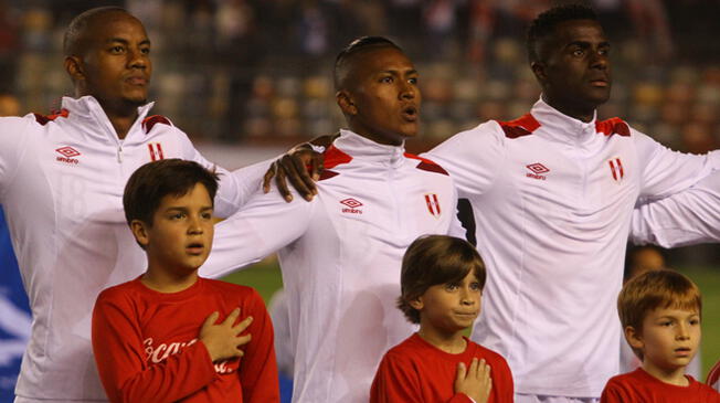 Pedro Aquino entona el himno nacional, flanqueado por André Carrillo y Christian Ramos.