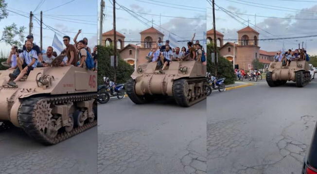 Hinchas argentinos celebran encima de un tanque de guerra la victoria de Argentina